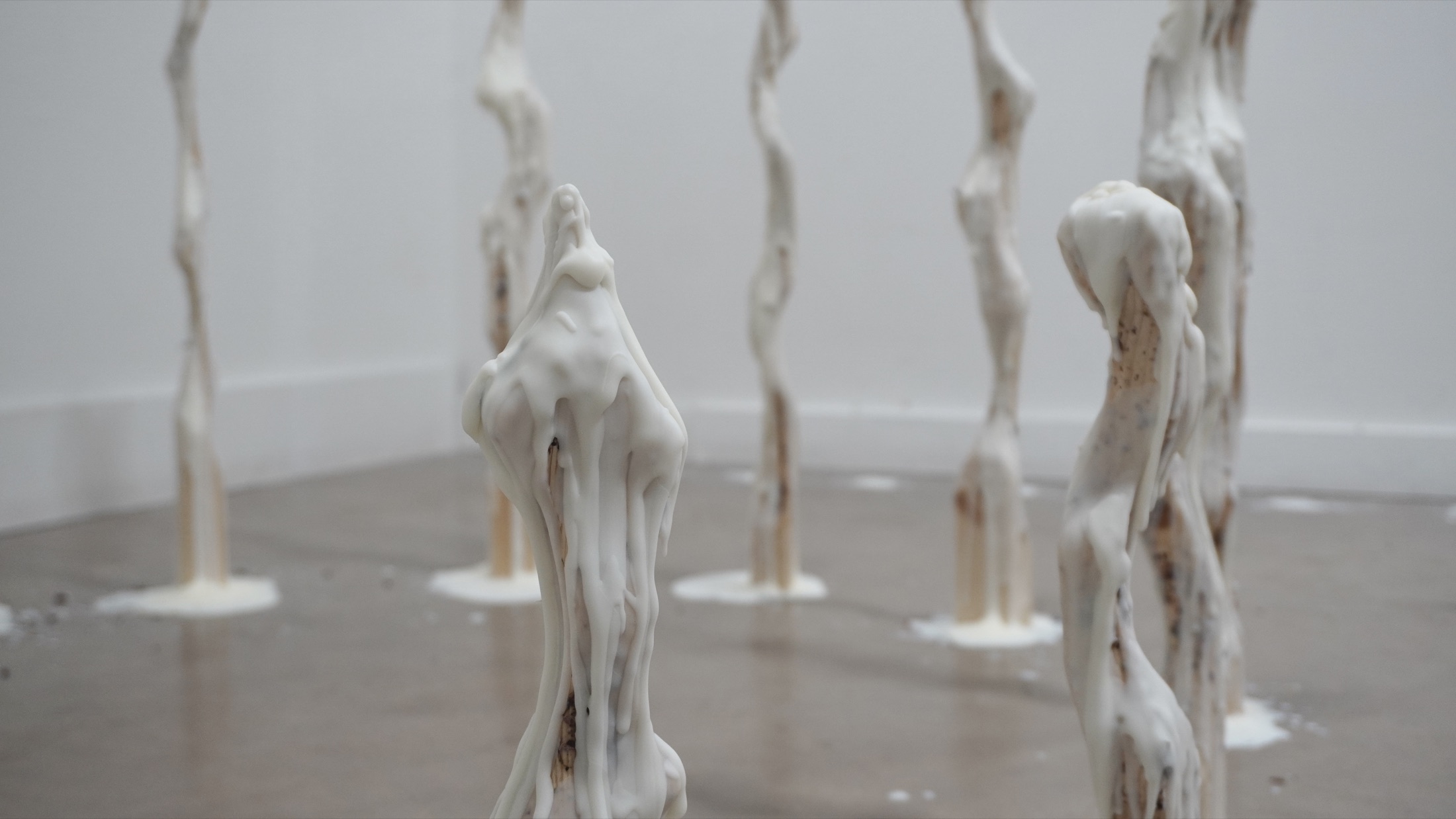 Wax sculptures arranged across the floor
