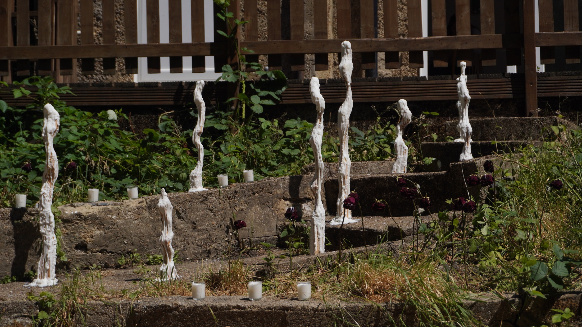 Outdoor installation beside a wooden structure