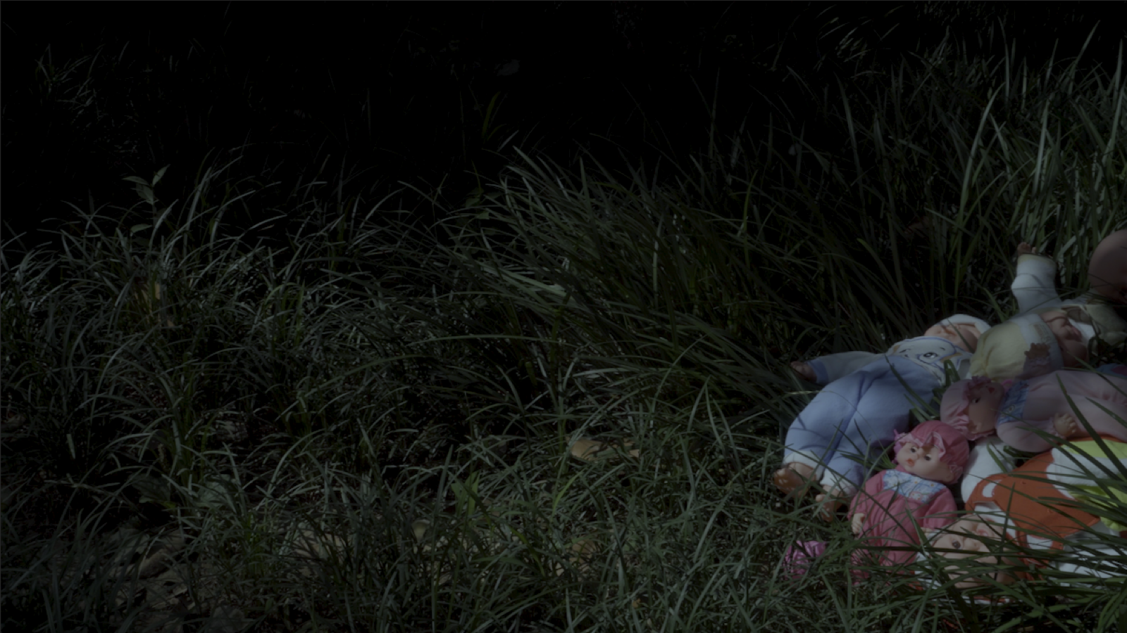 Woman lying in a dark rural landscape