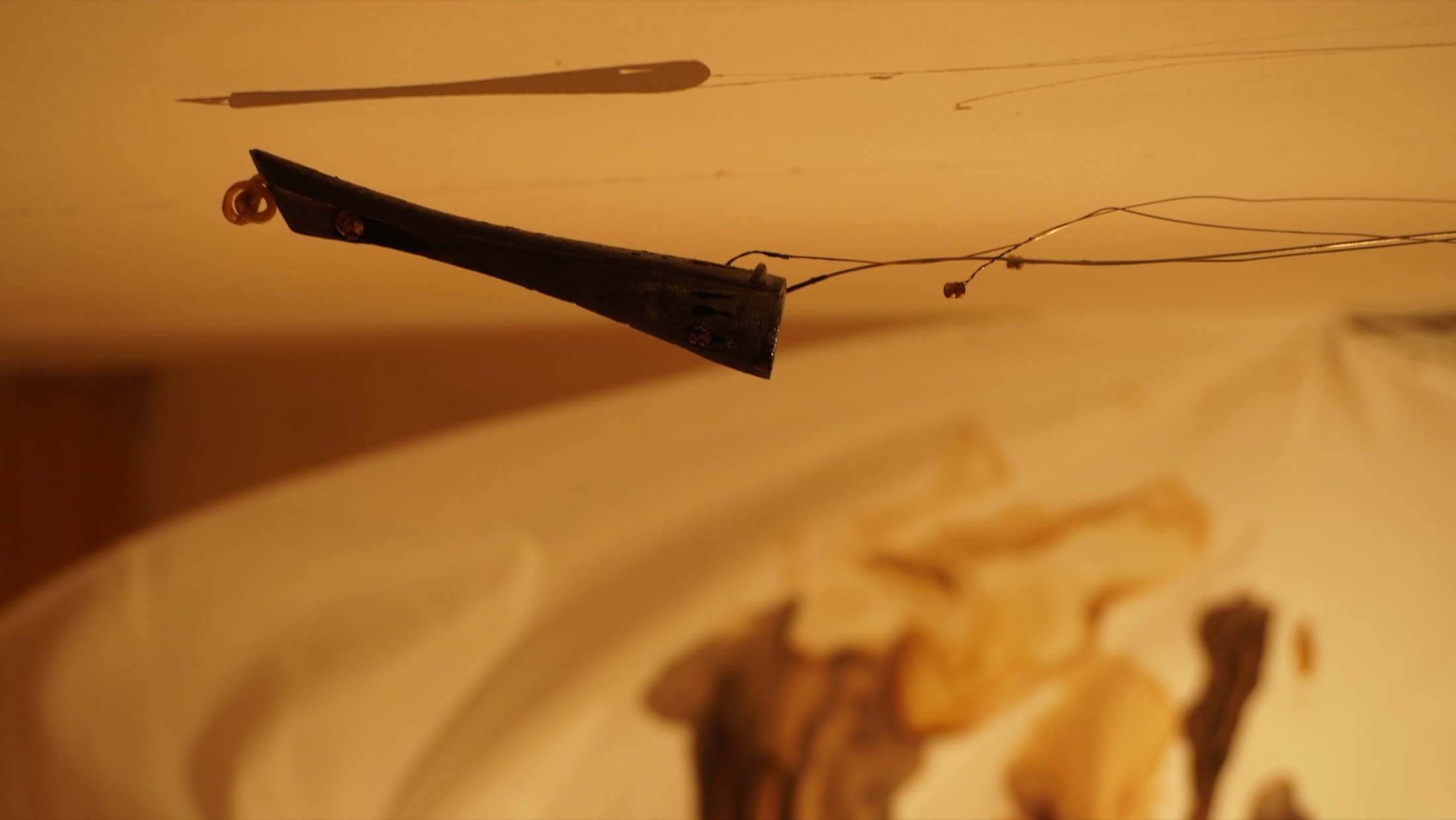 Vertical detail of fabric and burned instrument