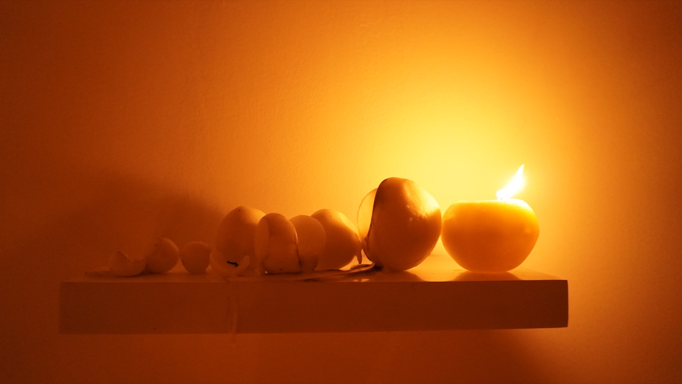 Candles glowing in the darkened installation